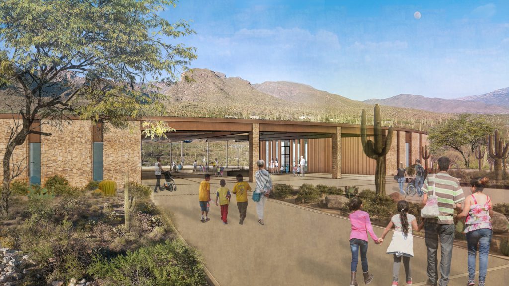 A rendering shows the exterior of the Sabino Canyon Visitor Center. The building has a modern design with a wooden roof and stone walls, blending into the desert landscape. People are seen walking along a path leading towards the entrance, with mountains visible in the background.